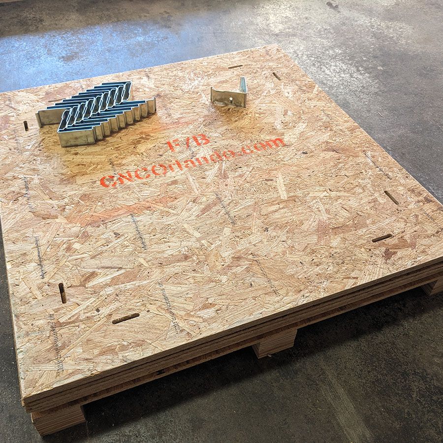 Crate panels packed flat with their removable metal clips